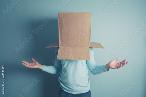 Confused man with cardboard box on his head photo