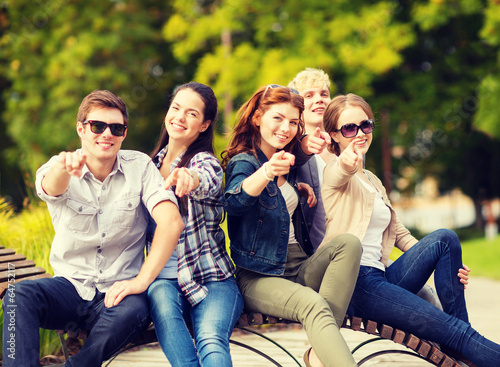 group of students or teenagers pointing fingers