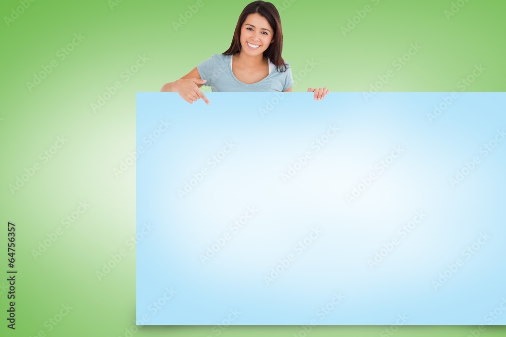 Composite image of pretty brunette showing card Composite image of pretty brunette showing card
