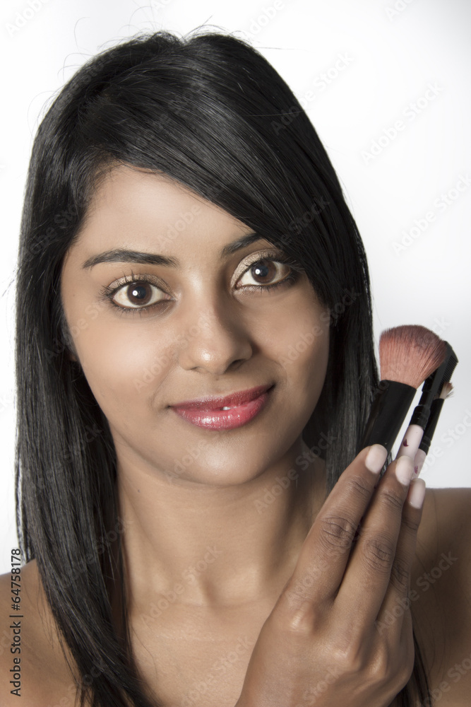 Beautiful Young Woman holding makeup brushes Beautiful Young Woman holding makeup brushes