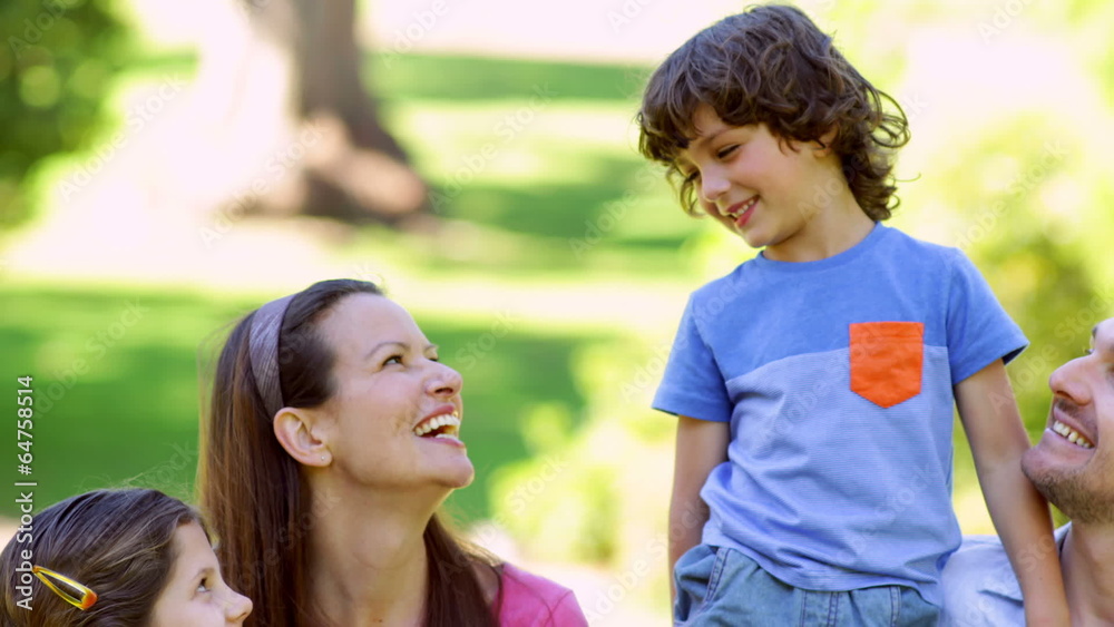 Cute family relaxing together in the park Cute family relaxing together in the park