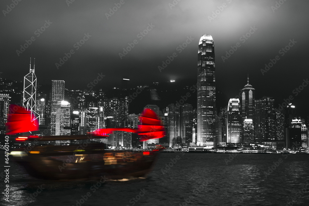 Fototapeta premium Hong Kong harbor at night with blurred silhouette of sailboat