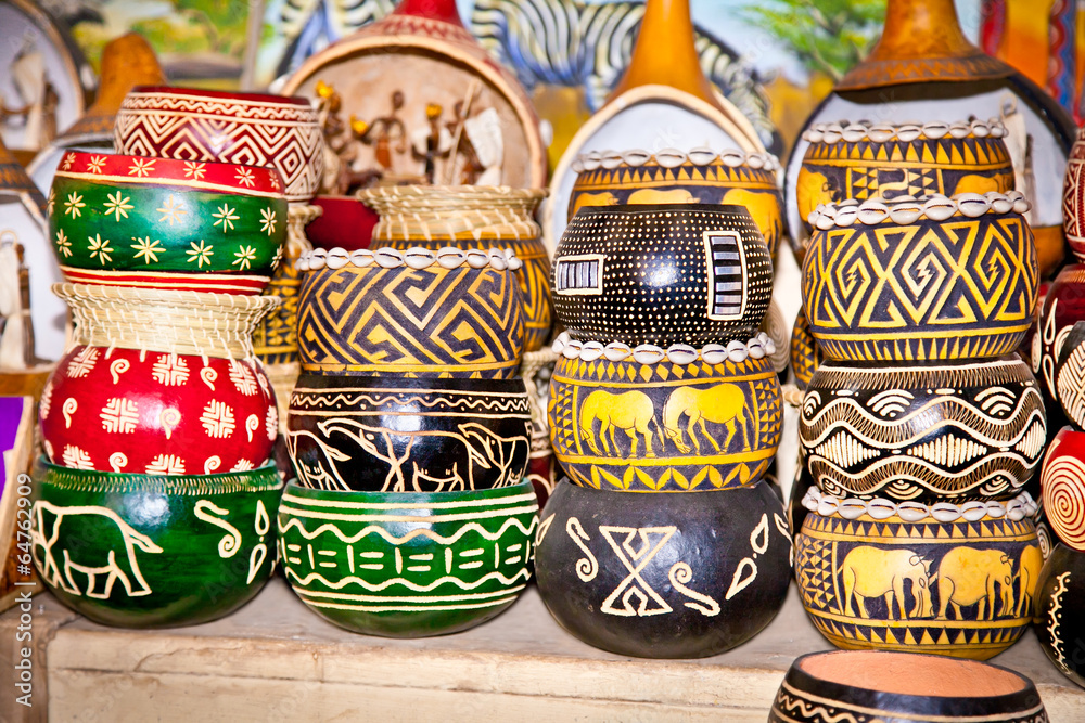 Fototapeta premium Colorfully painted wooden pots in market, Africa.