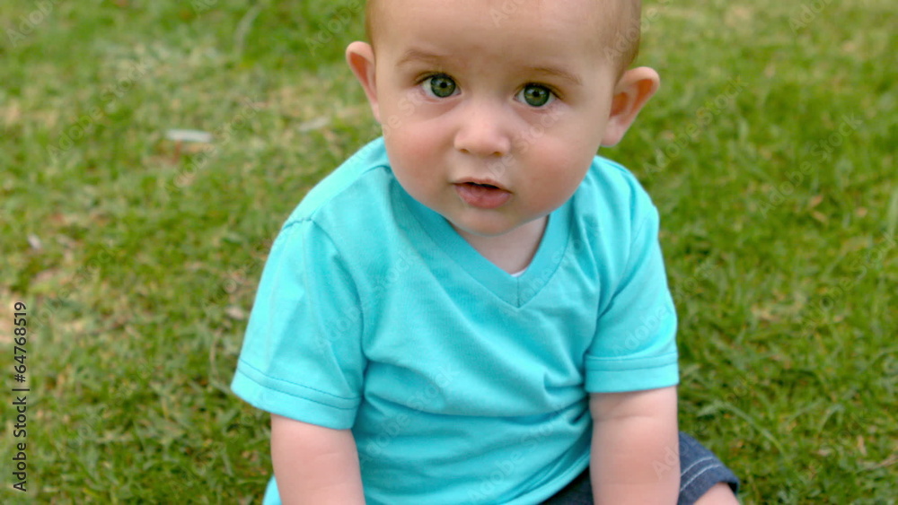 Cute baby sitting on the grass Cute baby sitting on the grass