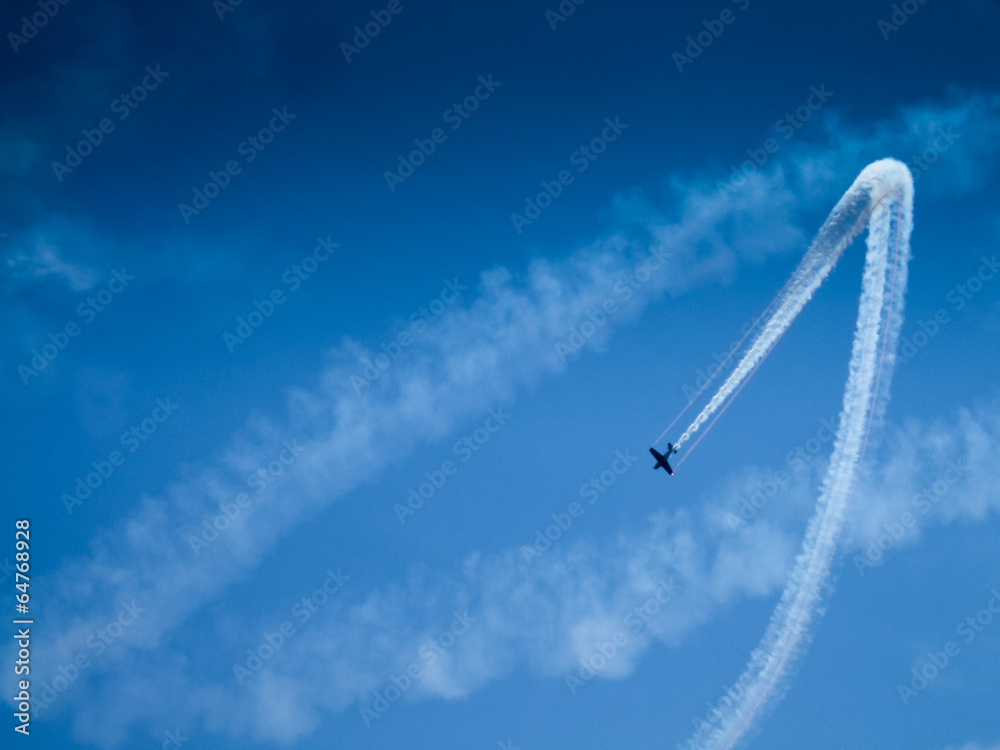 Low angle view of an airplane performing airshow Low angle view of an airplane performing airshow
