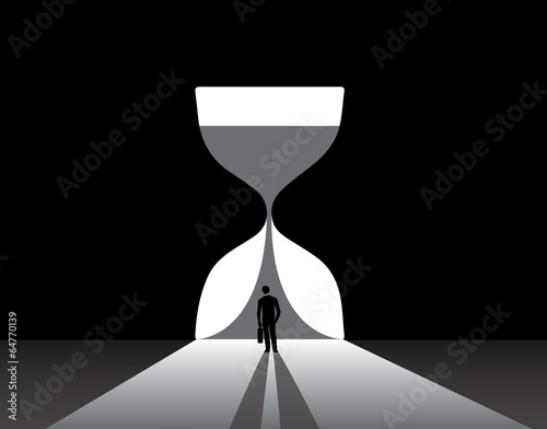 Businessman silhouette standing front of big hour glass door