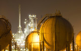 A large oil-refinery plant with gas storage tanks