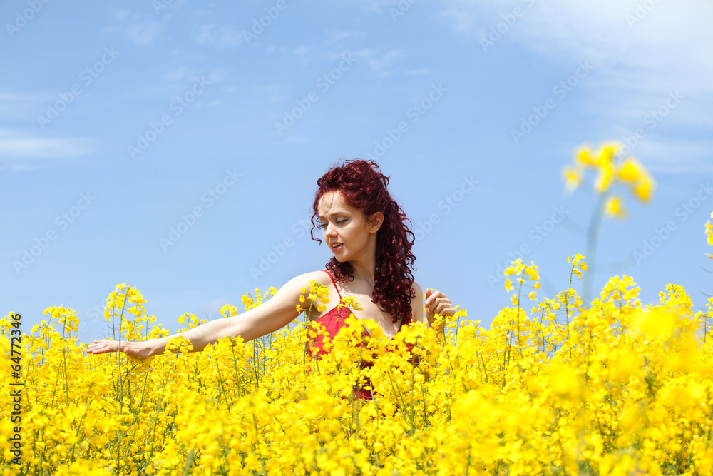 Woman enjoying in a rape field Woman enjoying in a rape field