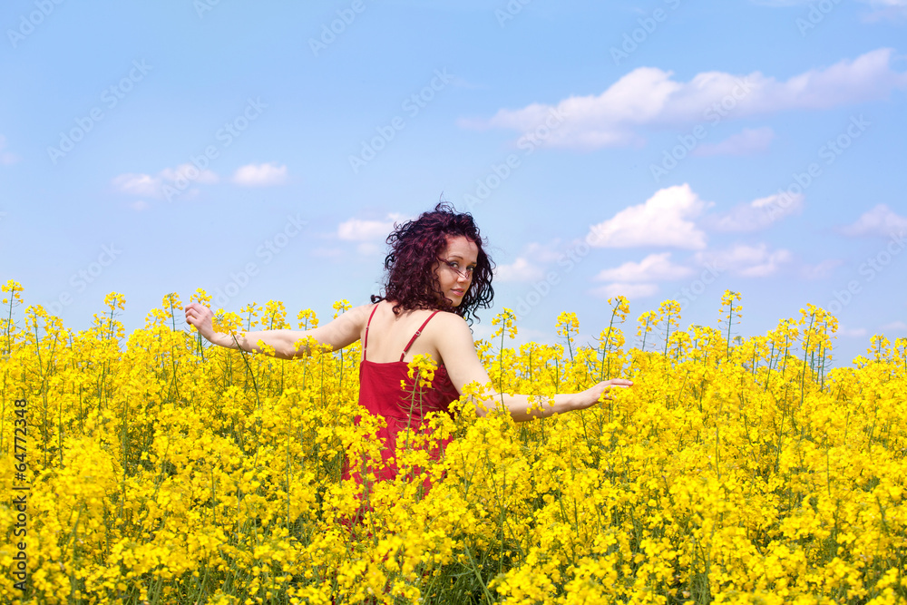 Woman enjoying in a rape field Woman enjoying in a rape field