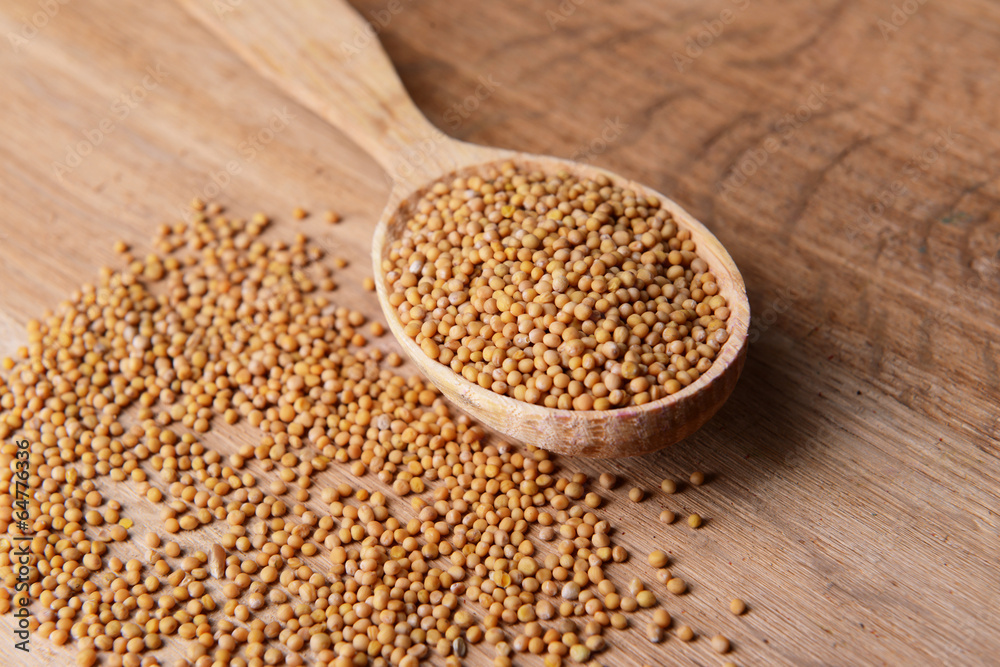 Spice mustard in spoon on wooden background Spice mustard in spoon on wooden background