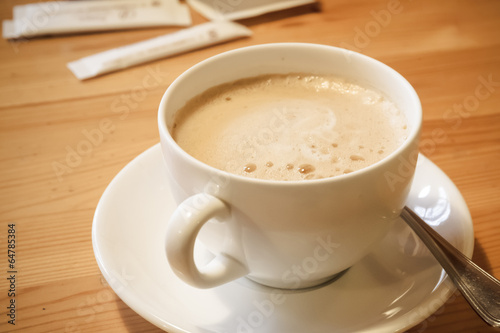 close up of a delicious cup of coffee on wooden table