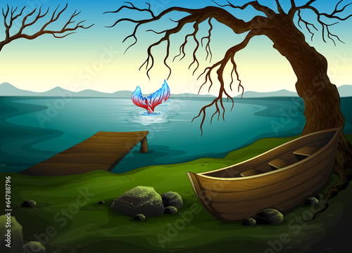 A boat under the tree near the sea with a big fish