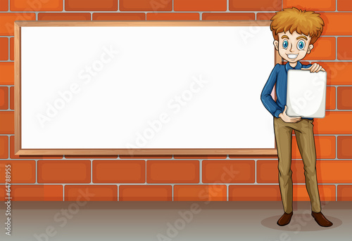 A tall businessman standing beside the empty whiteboard