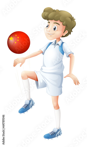 A boy using the soccer ball with the flag of China