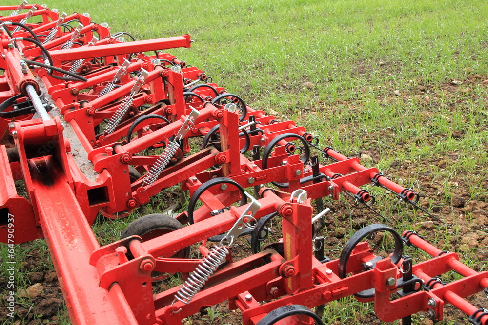 Harrow in green crop field after rainfall Harrow in green crop field after rainfall