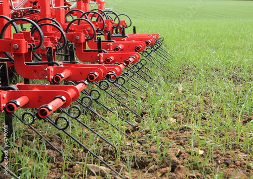 Harrow in green crop field after rainfall © chrisrt