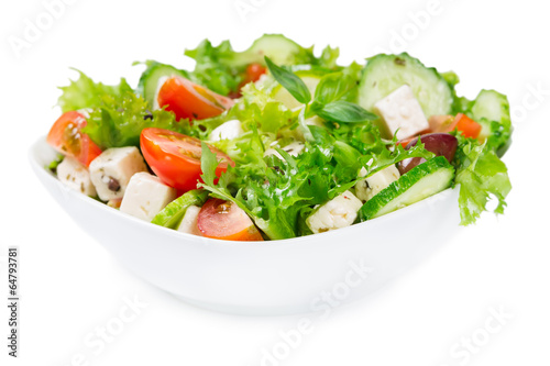 Salad with fresh vegetables in a ceramic bowl