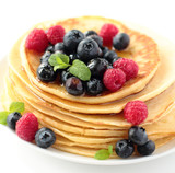 Stack of pancakes with fresh blueberry raspberry and honey