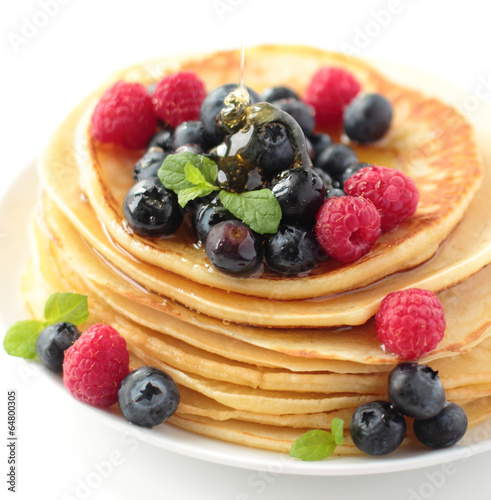 Stack of pancakes with blueberry raspberry and honey