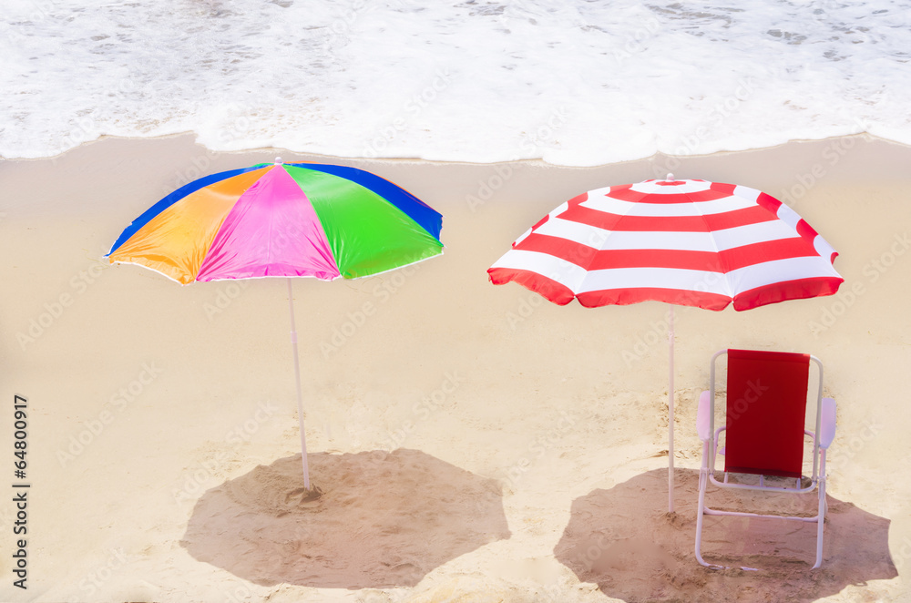 Beach umbrellas and chair by the ocean Beach umbrellas and chair by the ocean