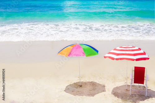 Beach umbrella and chair by the ocean