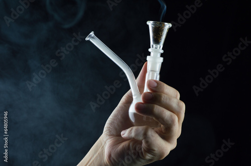 Cuadro en lienzo hand with a pipe and marijuana smoking on black