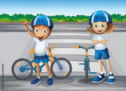 A girl and a boy with their bikes standing near the pedestrian l