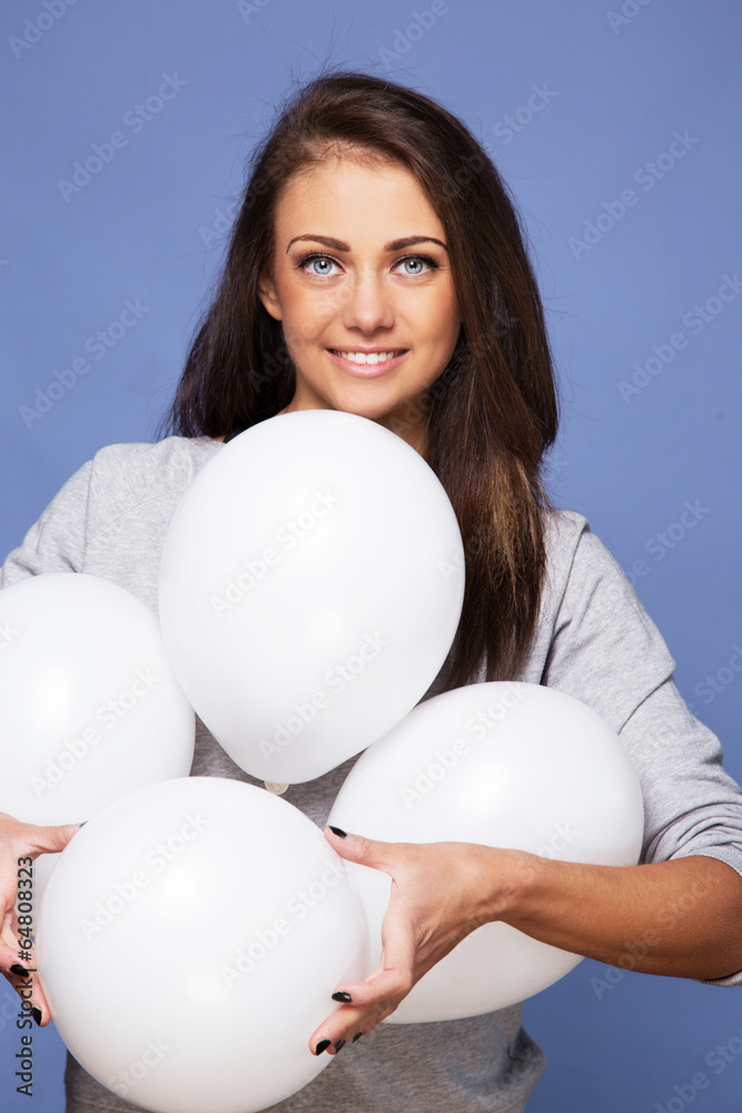 A smiling girl with white balloons A smiling girl with white balloons