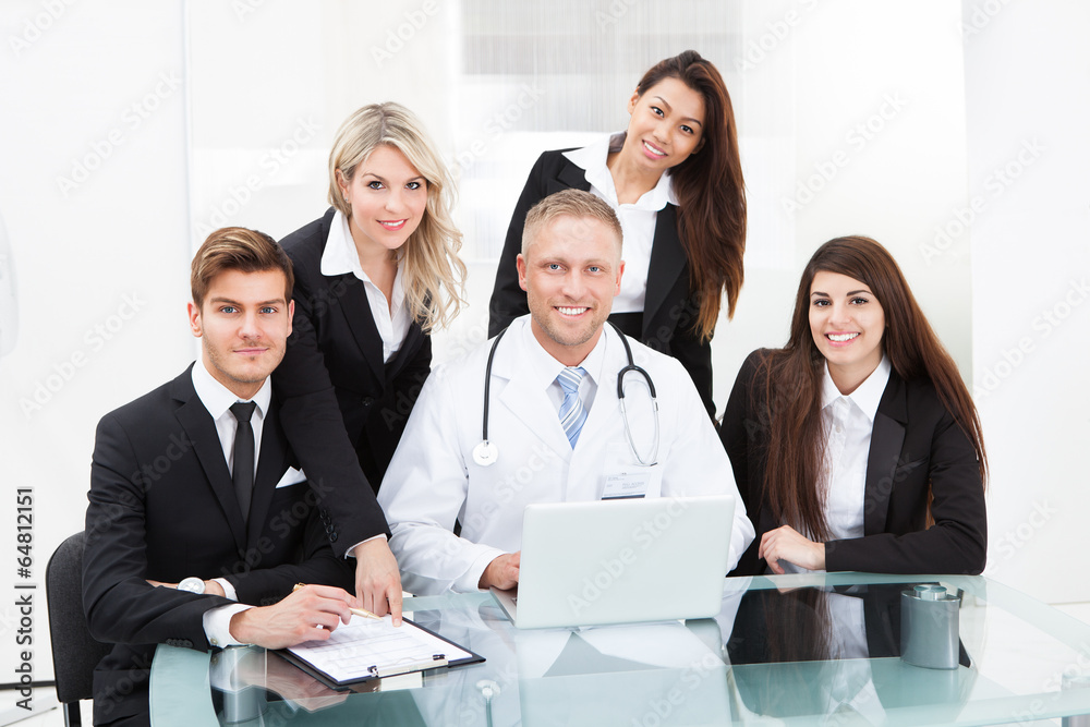 Doctor And Businesspeople Using Laptop Doctor And Businesspeople Using Laptop