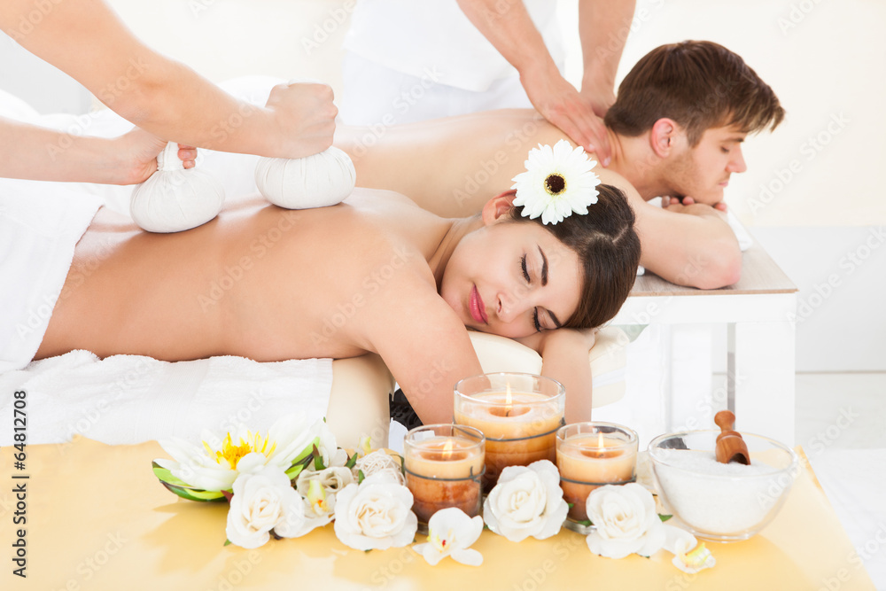 Couple Receiving Back Massage In Spa Couple Receiving Back Massage In Spa