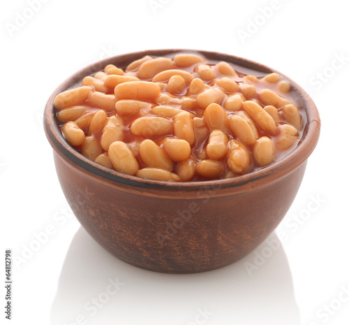 Cooked beans with red sauce in a clay bowl