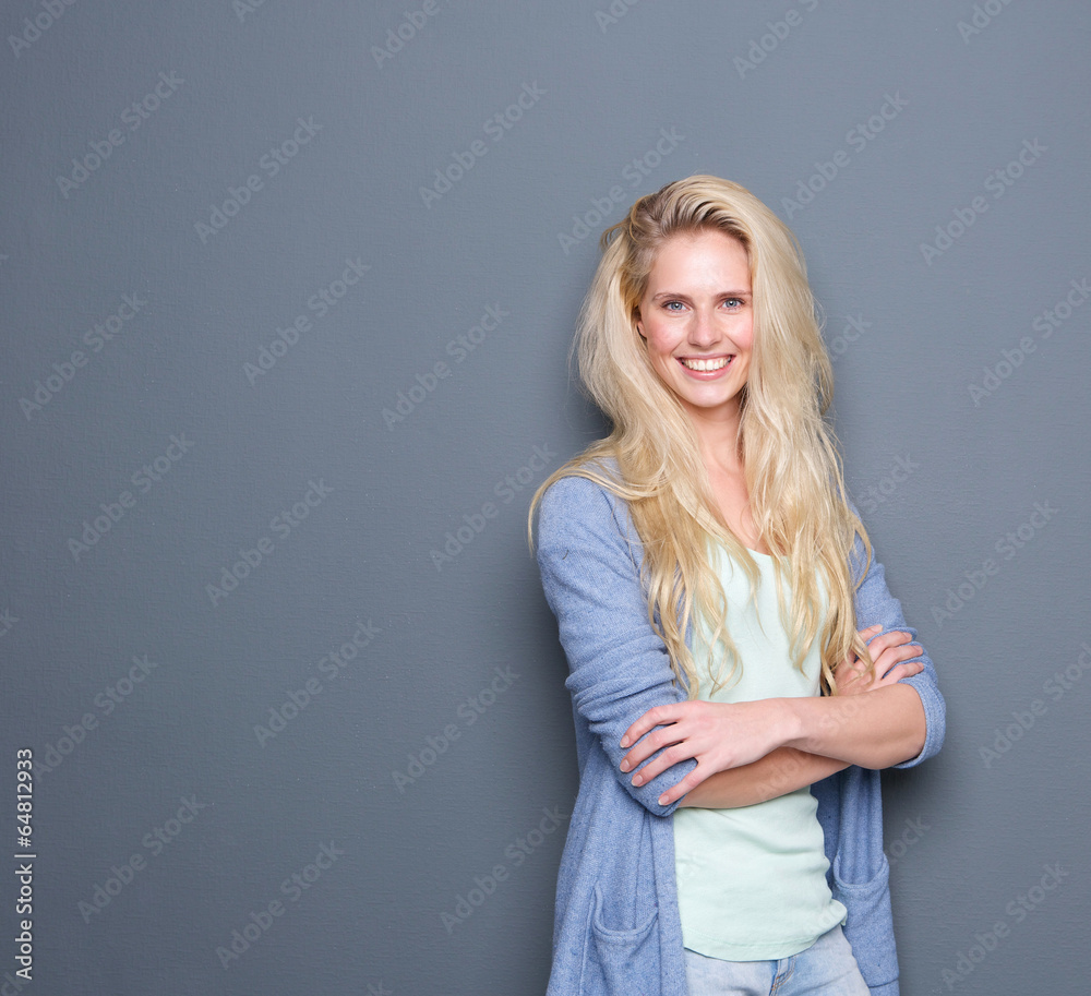 Blond woman smiling with arms crossed Blond woman smiling with arms crossed