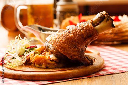 Photography eisbein with braised cabbage, salad and beer