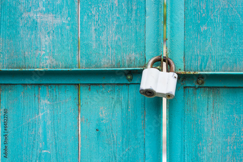 Closeup of wooden gate with padlock