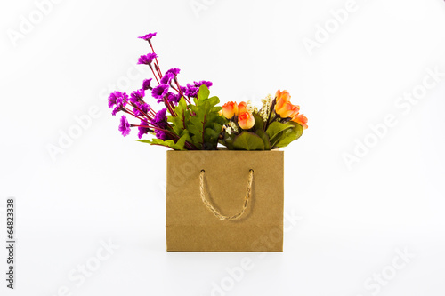 Artificial colorful of flowers in shopping bag.