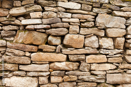 of rough stone wall of big and small rocks