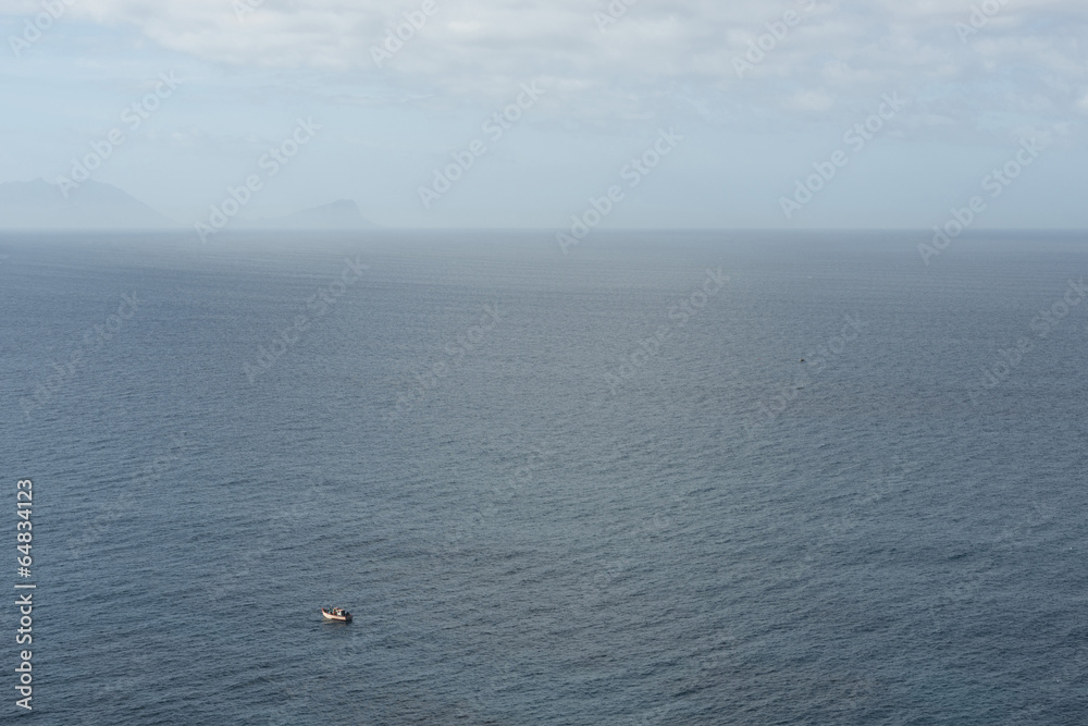 little fishing boat on huge ocean