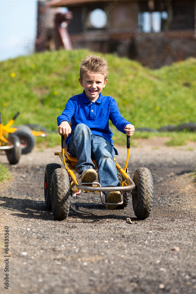 Caucasian boy having fun in moon buggy