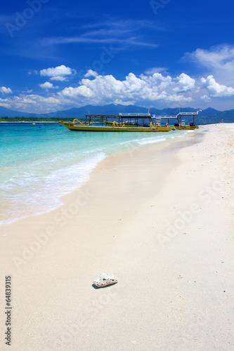 Beach on Gili Trawangan island with yellow boats