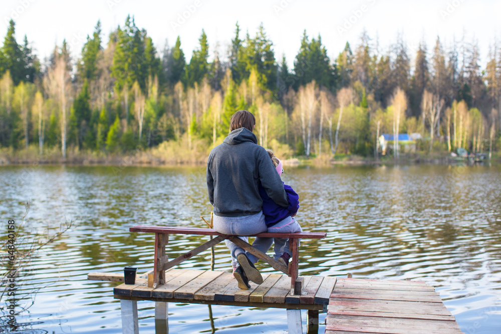 Young dad and little girl fishing on the lake Young dad and little girl fishing on the lake