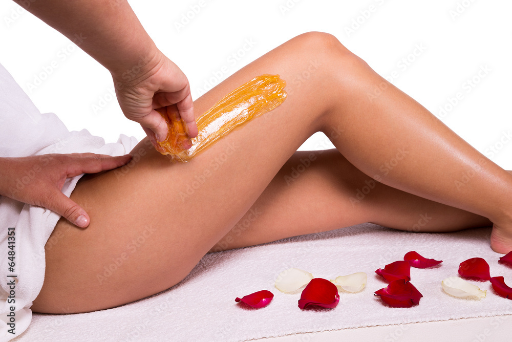 Sugaring: epilation with liquate sugar at legs. Photos | Adobe Stock