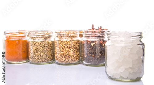 Different variety of sugar and spices over white background