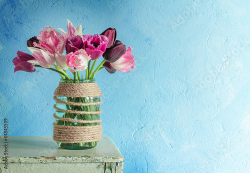 Fototapeta Naklejka Na Ścianę i Meble -  Tulips in a decorated glass jar