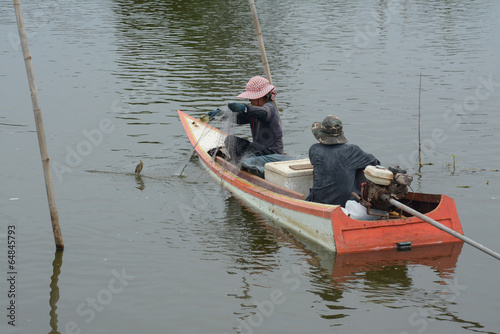 Fishing in wooden boat used net
