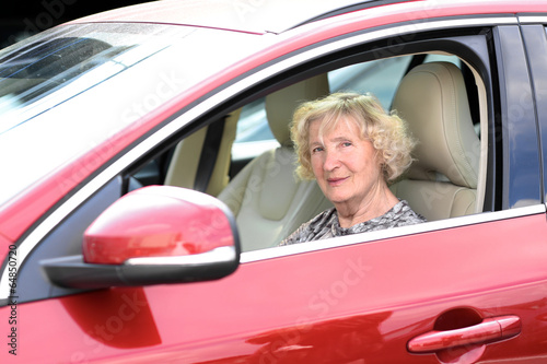 Active senior woman in the modern car