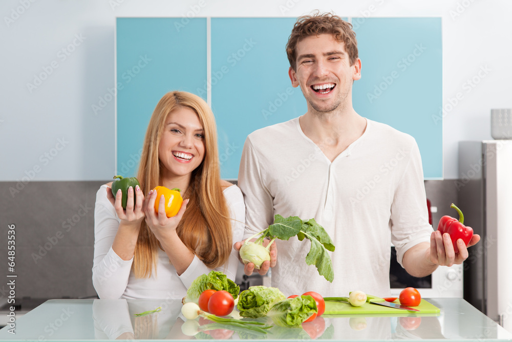 Young beautiful couple cooking at home
