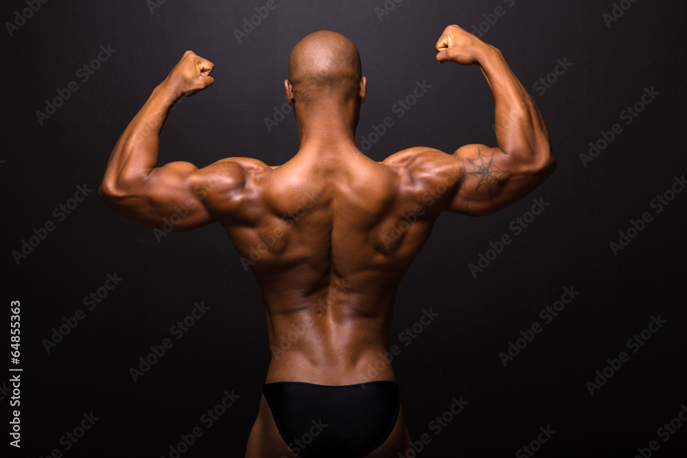 rear view of afro american male bodybuilder posing rear view of afro american male bodybuilder posing