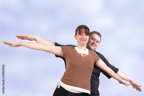 Man and woman stretching her arms out with joy