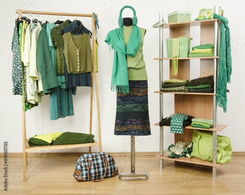 Dressing closet with green clothes,autumn outfit on a mannequin. photo