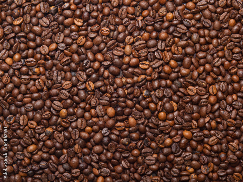 Numerous coffee beans which have been scattered all over the sur Numerous coffee beans which have been scattered all over the sur
